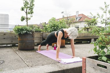 Woman practising yoga on a roof terrace