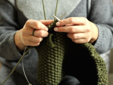 Close-up view of a woman's hands knitting