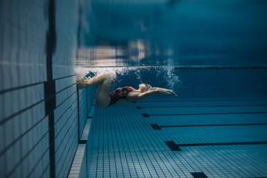 Female swimmer in action inside swimming pool