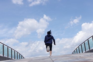 Rear view of woman running outdoors