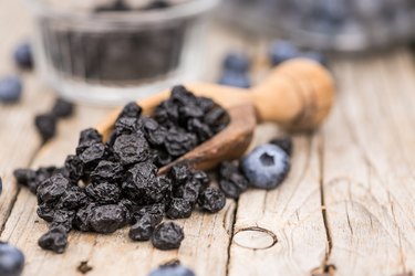 Dried Blueberries on wooden background; selective focus