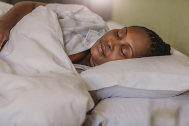 Person sleeping soundly in their bed at home