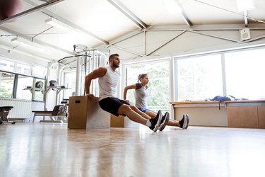 Friends working out in a home gym