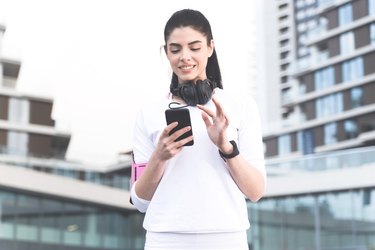 Woman using walking app to track walking workout