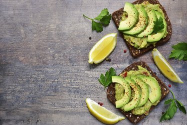 Delicious wholewheat toast with guacamole and avocado slices.