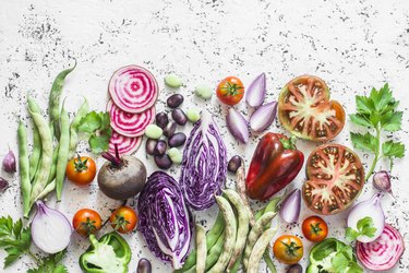 Organic fresh vegetables background. Cabbage, beets, beans, tomatoes, peppers on a light background, top view. Flat lay