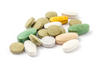 Close-Up Of Colorful Pills Over White Background