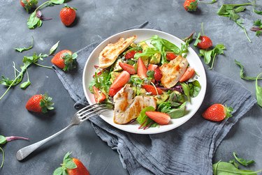 Plate of salad with chicken, strawberries and avocado