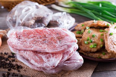 Frozen pork neck chops meat and pork schnitzel in a plate