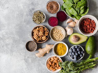 Healthy clean food - vegetables, fruits, nuts, superfoods on a gray background. Healthy eating concept. Top view.