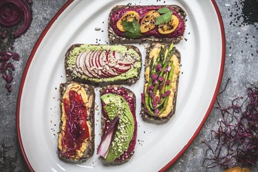 Multicoloured hummus on toasts Vertical