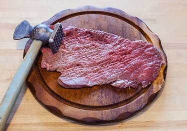 meat tenderizer and beaten slice of veal