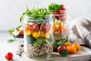 Salad in glass jar with quinoa for healthy lunch recipes