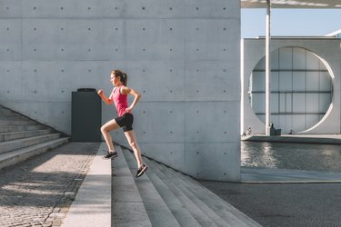 sports woman running up stairs outdoors