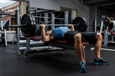 Man during bench press exercise as part of a full-body workout