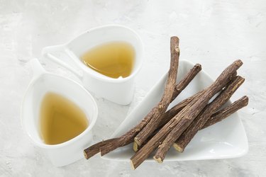 Licorice tea and roots on white background to show Egyptian liquorice root tea benefits and why to buy liquorice tea