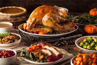 Homemade Roasted Thanksgiving Day Turkey, a food high in taurine, surrounded by thanksgiving sides.