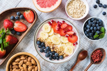 Smoothie bowl with banana, strawberry, blueberry, granola and pomegranate