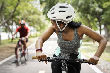 Cyclist couple riding bikes in a park