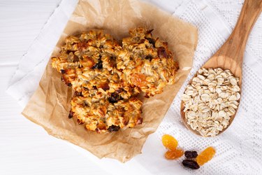 Healthy oatmeal cookies with raisins on white table. Top view.