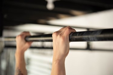 Hands on pull-up bar for at-home strength training workout