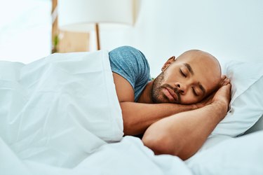 man sleeping in bed