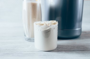 Close-up scoop with portion of dry protein powder
