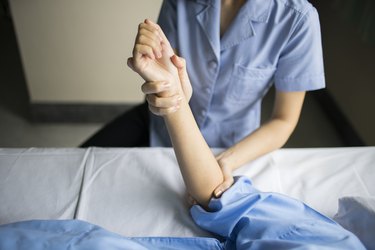 close up hand of therapist rehab physical therapy patient hand