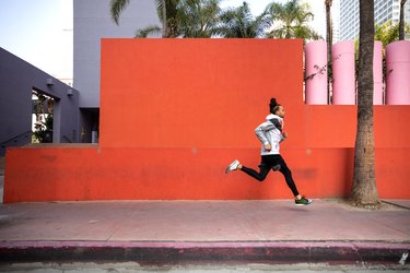 Young afroamerican man getting fit in Los Angeles downtown city streets
