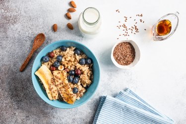 Oatmeal porridge in bowl with flax seeds and fruits