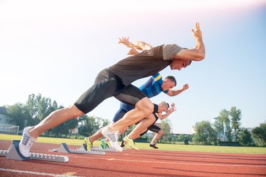 Runners preparing for race at starting blocks