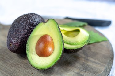 Two ripe raw hass avocados close up