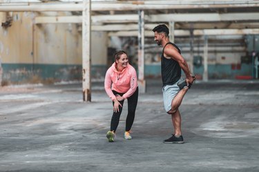 Man and woman stretching their legs