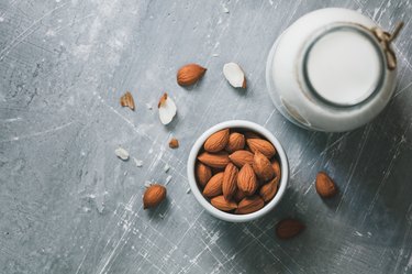 Directly Above Shot Of Almonds By Milk On Table