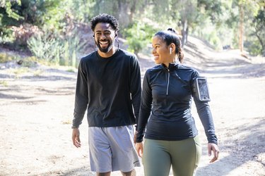 Couple walking outside for exercise and stress relief