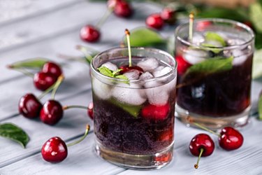 Tart cherry juice on wooden background