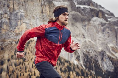 Man running in mountains in workout clothes for men