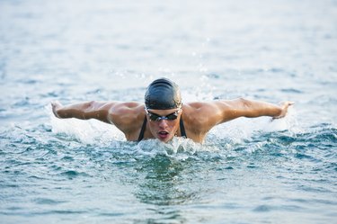 Female swimmer at butterfly stroke in the sea