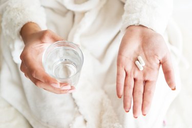 Woman taking multivitamins at night