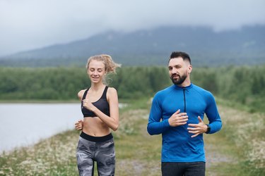 Trainer and female sportsman jogging outdoor