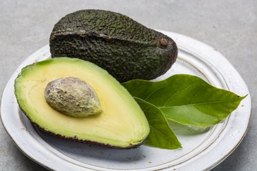 New harvest of fresh ripe hass avocado, cut in half