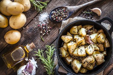 Roasted potatoes on wooden kitchen table