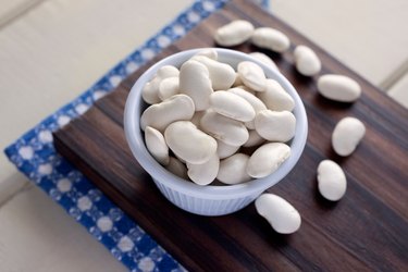 High Angle View Of Lima Beans In Bowl On Cutting Board