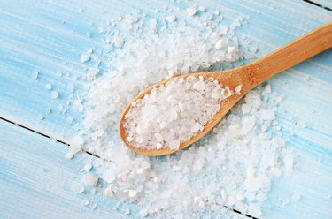 Sea salt on wooden table wooden spoon