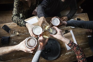 friends at a pub toasting