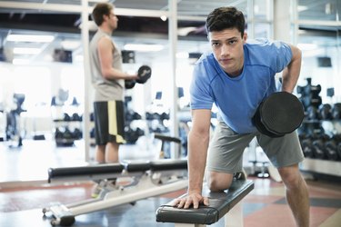 Man lifting weights in fitness center