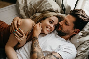 Couple lying in bed together