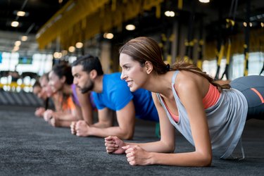 Group of people at the gym in a suspension training class