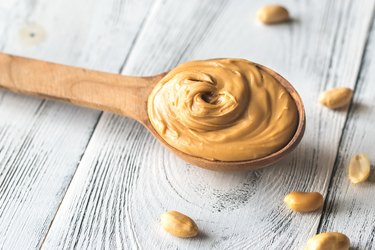 Wooden spoon of peanut butter