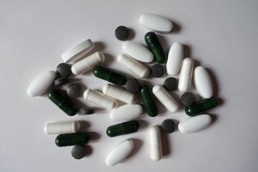 Top view of green, white and black pills